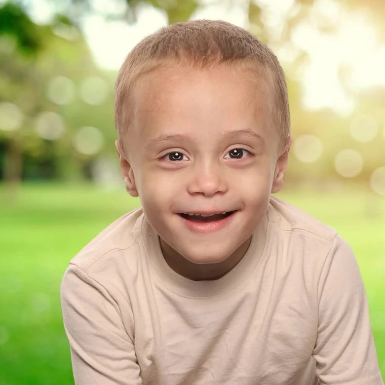 My nephew, smiling outdoors on a summer afternoon